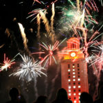 Fireworks in front of the UT Tower, which is lit up in orange light