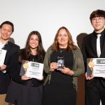 Group of students and professionals pose with awards
