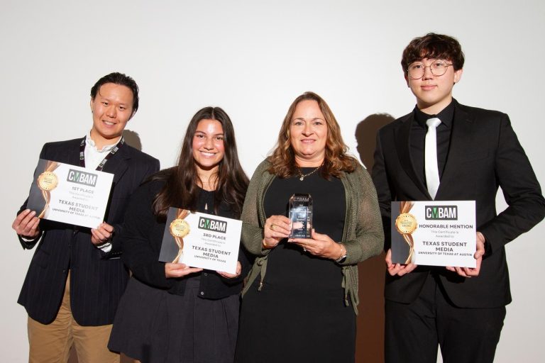 Group of students and professionals pose with awards